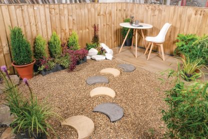 5 moonstone stepping stones- crescent moon stepping stones on a gravel pathway- leading to a white table and chair