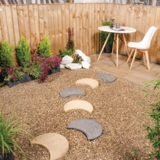 5 moonstone stepping stones- crescent moon stepping stones on a gravel pathway- leading to a white table and chair