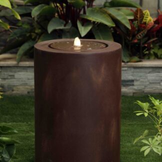 'Zen' rust coloured cylinder in a green garden